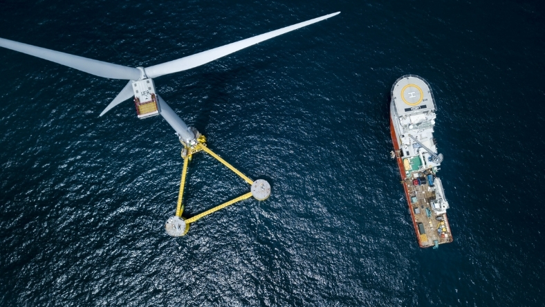Floating offshore wind turbine anchored in deepwater beside installation vessel
