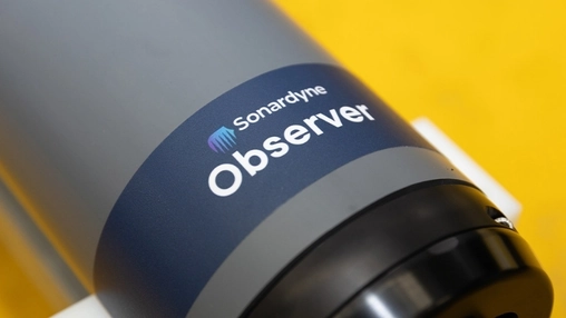 Close-up of Sonardyne Observer instrument showing product name and brand logo on a cylindrical grey casing