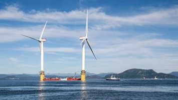 Floating offshore wind turbines on platforms with vessel nearby